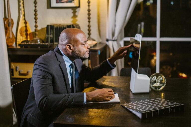 Businessman using a computer at home office during the evening.
